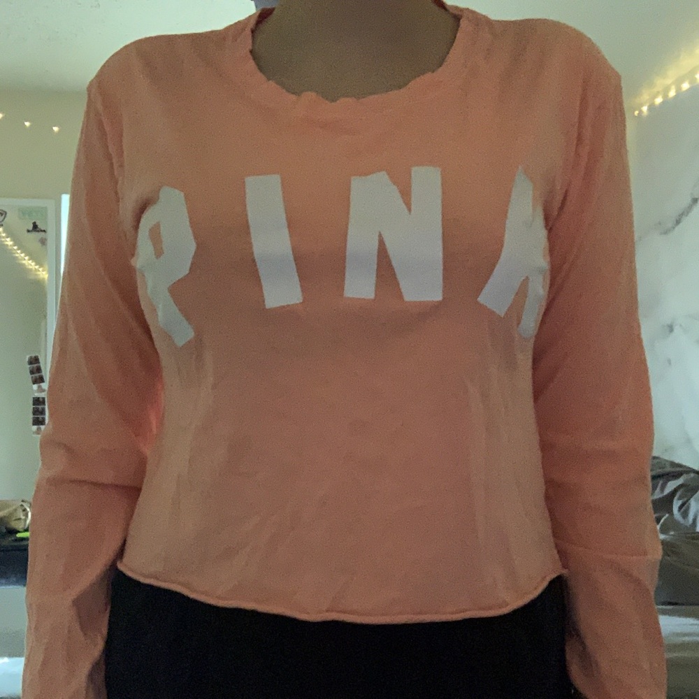 PINK coral long-sleeved crop top.